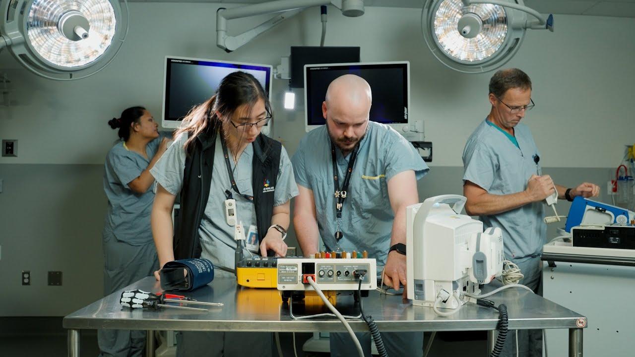 Biomedical engineer supporting medical equipment